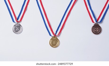 Gold silver and bronze demonstration trophy medals with ribbon for school university or national or olympic sport even organization competition. Isolated on white background. Award and victory concept - Powered by Shutterstock