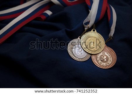 Gold, silver and bronze medal with numbers One, Two and Three. Sport trophy. Blue background. Original photo for winter olympic game in pyeongchang 2018.