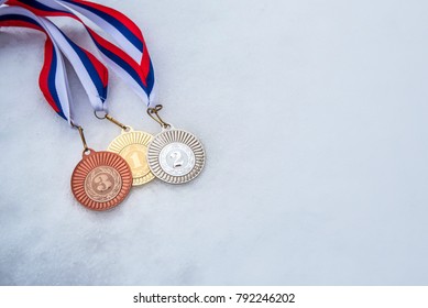 Gold, Silver Bronze Medal. White Snow Background. Wallpaper For February Winter Olympic Game In South Korea.