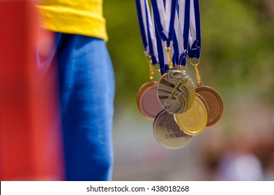 Gold, Silver And Bronze With Symbol Of Running Athlete. Nice Wallpaper For Summer Olympic Game In Rio