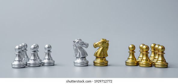 Gold and silver Chess Knight (horse) figure on Chessboard against opponent or enemy. Strategy, Conflict, management, business planning, tactic, politic, communication and leader concept