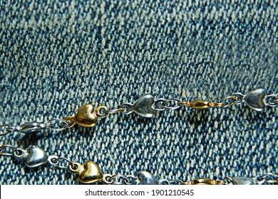 Gold And Silver Heart Necklace On Jeans Background