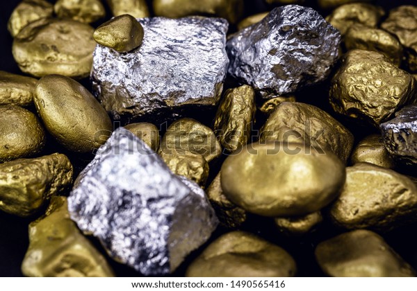 Gold and silver nuggets on black background.\
Precious stones, luxury concept and mineral drainage. Industrial\
activity, treasure and\
fortune.