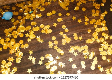 
Gold Spangles And Confetti On The Floor After The Holiday. The Aftermath Of Fun