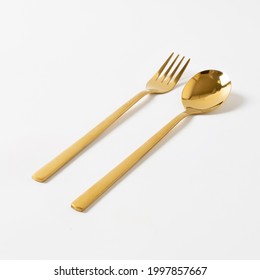 Gold Spoon And Fork Isolate On White Background