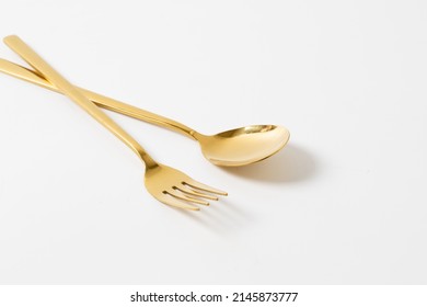 Gold Spoon And Fork Isolate On White Background