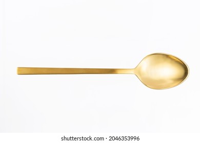 Gold Spoon On White Background