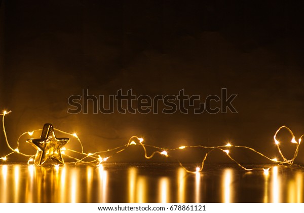 Gold star and light christmas that black\
background. color filter vintage\
tone.