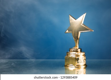 Gold Star Trophy In Smoke, Blue Background