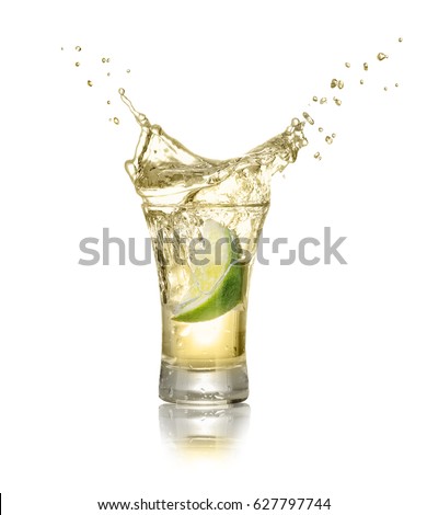 gold tequila shot with splash isolated on white background. Lime is falling in the alcohol drink