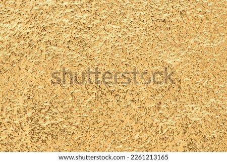 Gold texture or background. Embossed golden metal pattern. Abstract shiny yellow.