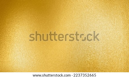 Gold texture background with yellow foil luxury shiny shine glitter sparkle of bright light reflection on golden surface, for celebration backdrop, wallpaper, Christmas decoration background design