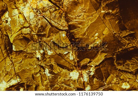 Gold texture. Rough structure mineral. Rock texture. Gold Ore. Gold rocks. Stone background. 