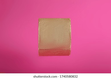 Gold Toilet Paper On A Pink Background