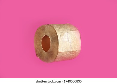 Gold Toilet Paper On A Pink Background