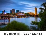 Gold Tower Bridge and Sacramento River in Sacramento, California, photographed from River Walk Park at night.