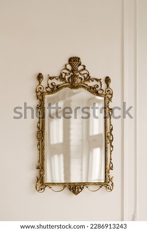 Gold vintage mirror on a white wall background