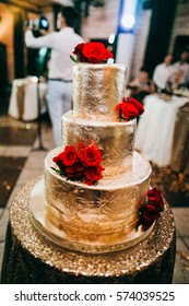 Gold Wedding Cake With Red Roses 