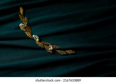 Gold Wedding Hair Accesories On Green Fabric