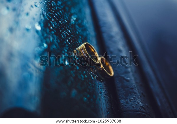gold wedding rings on the\
car window
