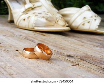 Gold Wedding Rings On A Wood Floor