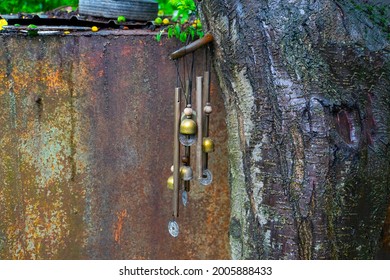 Gold Wind Bell Under The Tree At Rainy Day