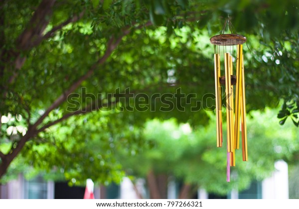 Gold wind bell under the\
tree
