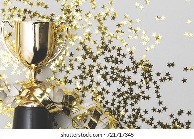 Gold winners trophy with golden shiny stars