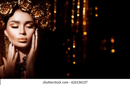 Gold Woman holiday makeup. Beauty fashion model girl with Golden make up, hair and jewellery on glowing background. Gold wreath and necklace. Fashion art portrait, Hairstyle, manicure and make up.