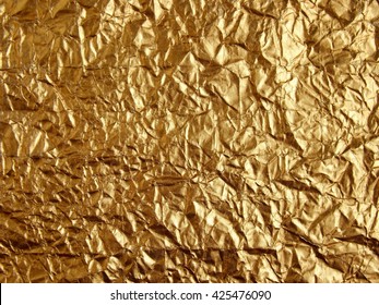 Gold wrinkled paper texture abstract background.