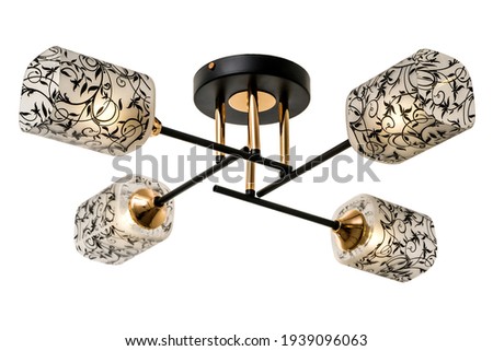 Gold-black four-lamp ceiling lamp with rectangular matt shades with black floral ornaments. Isolated on white background