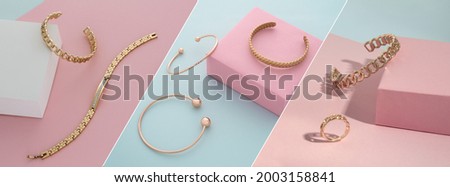 Golden accessories collection on pastel colors pink and blue background