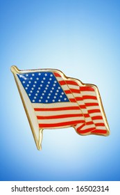 Golden American Flag Lapel Pin Against A Blue Gradient Background