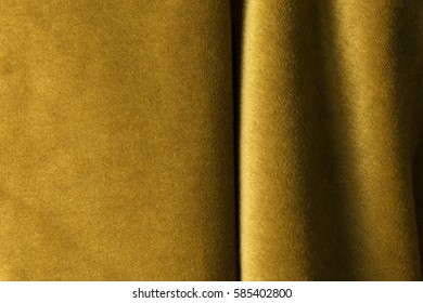 Golden angora goat velours fabric resembling velvet, mixed with natural silk threads. mohair textile. cashmere, velvet suede and chamois effect. for upholstery