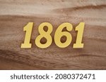Golden Arabic numerals 1861 on a dark brown to white wood grain background.