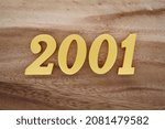 Golden Arabic numerals 2001 on a dark brown to white wood grain background.