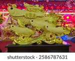 The golden arowana statue is believed to bring good luck in Chinese culture.