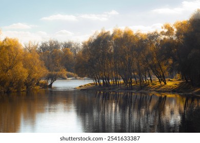 Golden autumn trees lining the riverbank, their reflections creating a symmetrical view on a calm fall day. - Powered by Shutterstock