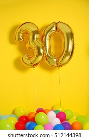 Golden Balloons For 30th Birthday Celebration On Yellow Wall Background