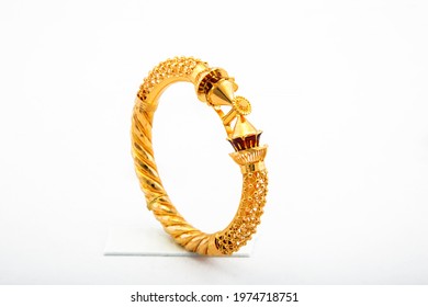 Golden Bangle With Beautiful Work Close View Ideal For Wedding Isolated On White Background. Gold Jewellery Stock Photo.