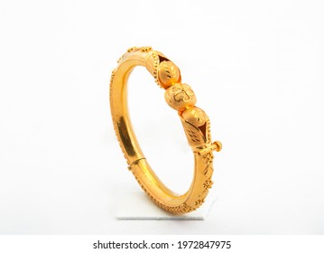 Golden Bangle With Beautiful Work Side View Ideal For Wedding Isolated On White Background. Gold Jewellery Stock Photo.