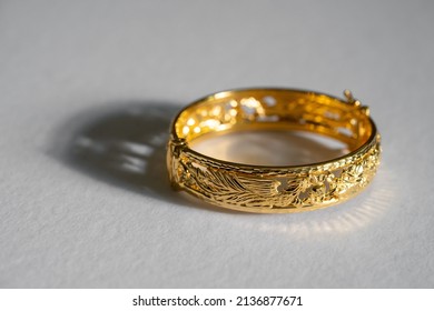 Golden Bangle On Isolated White Background. Chinese Wedding Traditional Golden Bangle As Gift For The Bride.