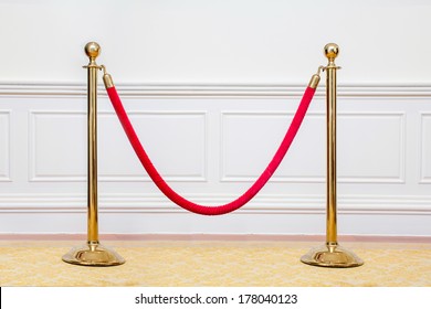 Golden barricade with red rope isolate on white background  - Shutterstock ID 178040123