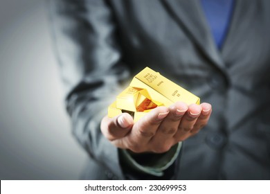 Golden bars on the woman's hand