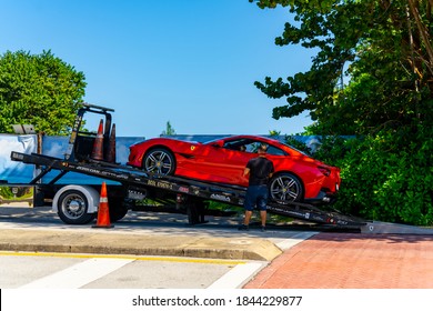 GOLDEN BEACH, FL, USA - OCTOBER 28, 2020: Luxury car delivery Ferrari on a flatbed tow truck