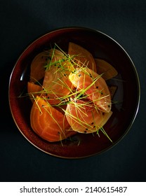 Golden beetroot salad above dark background - Shutterstock ID 2140615487