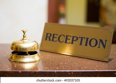 Golden Bell And A Sign In The Hotel Reception