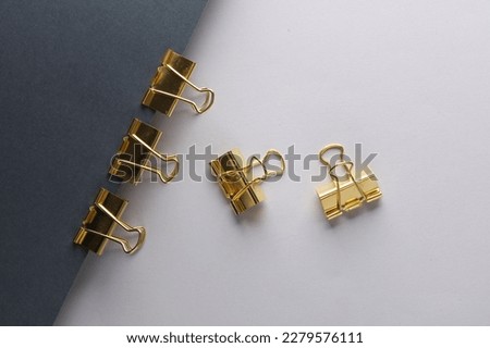 Golden binders on black and gray background. Creative layout. Minimalism composition. Top view