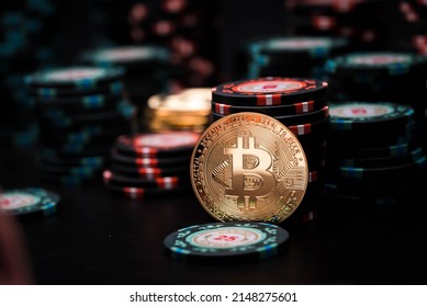 Golden bitcoin coin on the background of casino playing chips. Bitcoin casino game. Cryptocurrency excitement. Bet on bitcoins.