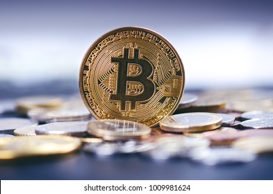 Golden bitcoin coins on a dark background with euro coins.  Virtual currency. Crypto currency. New virtual money. Lens flare  - Shutterstock ID 1009981624